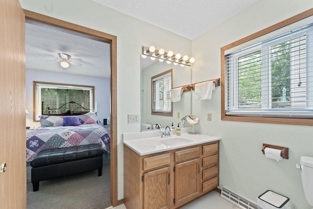 12129 221st Ave, Bristol, WI 53104 - ensuite bathroom with healthy amount of natural light, vanity, a textured ceiling, and ceiling fan