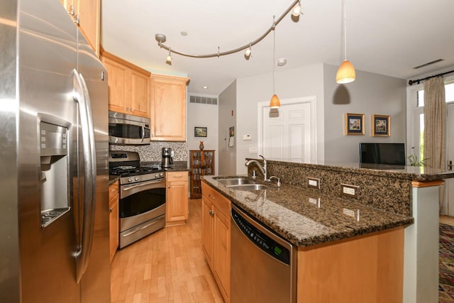1515 N Van Buren St Unit 414, Milwaukee, WI 53202 - kitchen featuring stainless steel appliances, light brown cabinetry, light wood-style flooring, decorative backsplash, and a kitchen island with sink