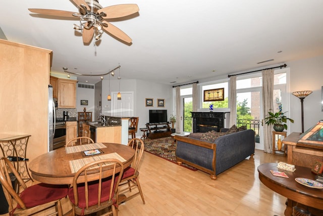 1515 N Van Buren St Unit 414, Milwaukee, WI 53202 - dining space featuring a ceiling fan, light wood finished floors, and a fireplace