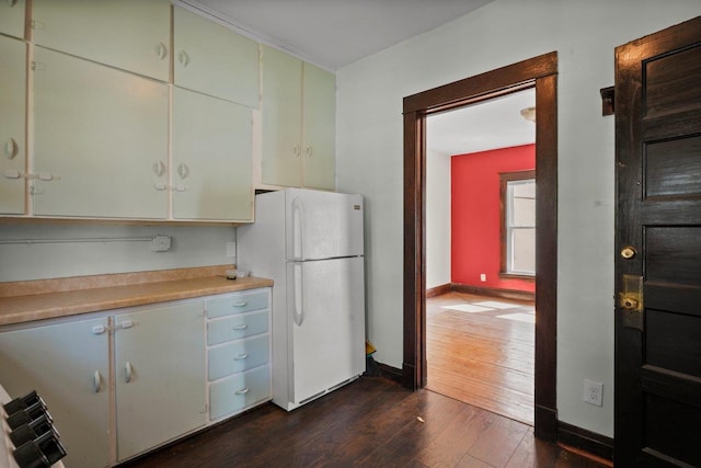 1049 E Johnson St, Madison, WI 53703 - kitchen with freestanding refrigerator, dark wood-style floors, and light countertops