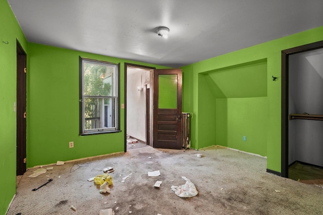 1049 E Johnson St, Madison, WI 53703 - unfurnished living room with baseboards and carpet