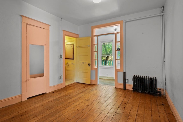 1049 E Johnson St, Madison, WI 53703 - spare room featuring radiator and hardwood / wood-style flooring
