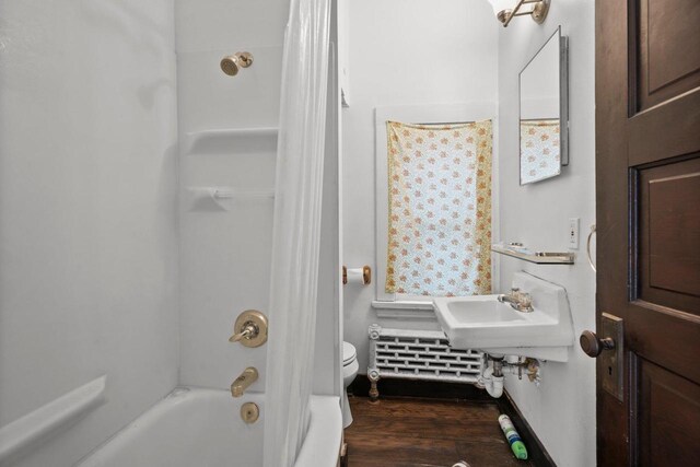 1049 E Johnson St, Madison, WI 53703 - full bathroom featuring wood finished floors and shower / bath combo