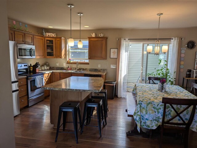 207 Sugar Maple Ln, Verona, WI 53593 - kitchen featuring appliances with stainless steel finishes, plenty of natural light, brown cabinetry, and recessed lighting