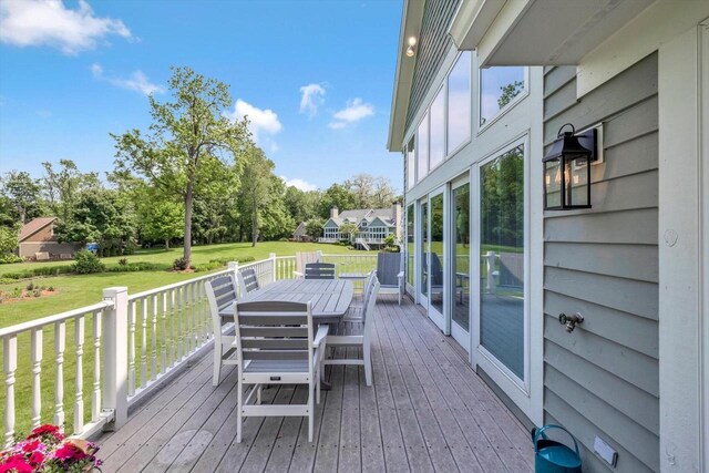1223 Milwaukee St Unit B, Delafield, WI 53018 - deck with outdoor dining space, a yard, and view of scattered trees