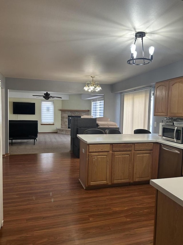 1304 W Garfield Ave, Milwaukee, WI 53205 - kitchen featuring stainless steel appliances, a chandelier, light countertops, and a fireplace
