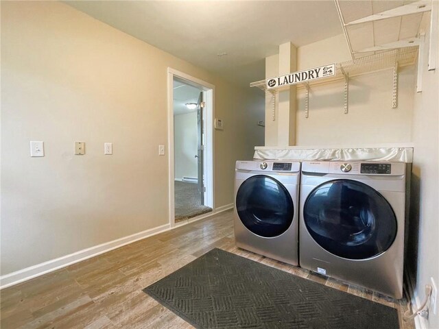 628 W Cedar St, Chippewa Falls, WI 54729 - laundry area with washer and clothes dryer and wood finished floors