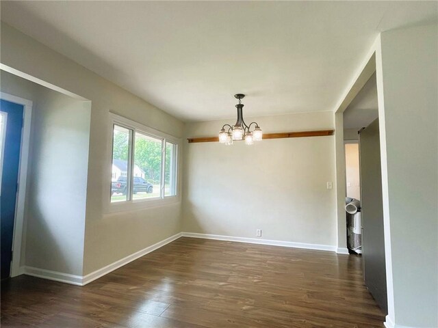 628 W Cedar St, Chippewa Falls, WI 54729 - empty room featuring dark wood-style floors and a chandelier