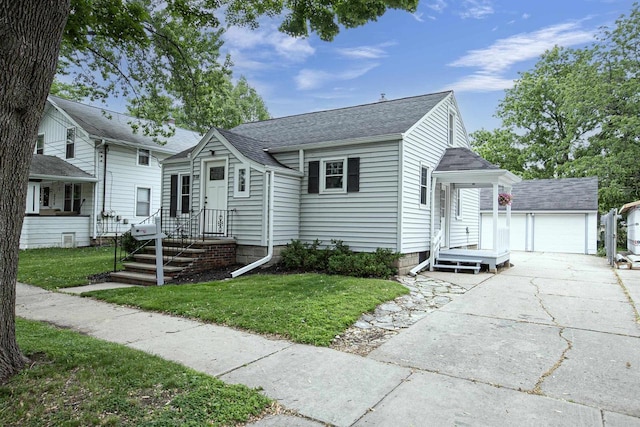 318 N Outagamie St, Appleton, WI 54914 - view of front facade with an outbuilding, a shingled roof, a front yard, and a garage