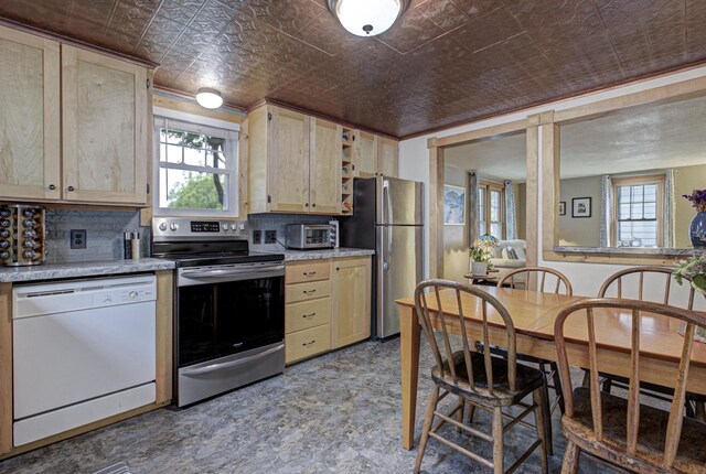 318 N Outagamie St, Appleton, WI 54914 - kitchen with stainless steel appliances, an ornate ceiling, light brown cabinets, decorative backsplash, and light countertops