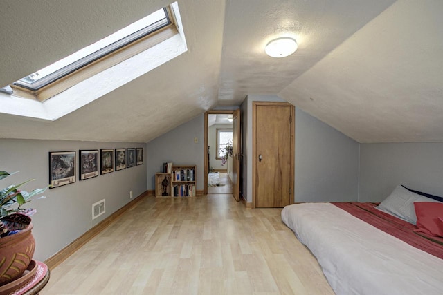 318 N Outagamie St, Appleton, WI 54914 - bedroom with a skylight, light wood finished floors, and lofted ceiling