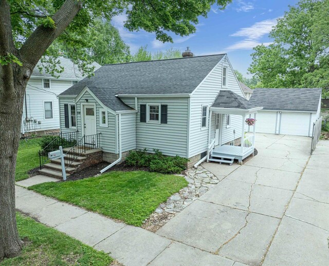 318 N Outagamie St, Appleton, WI 54914 - view of front of property with a shingled roof, a chimney, a detached garage, a front yard, and an outbuilding