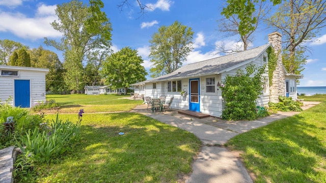 N133 Surfside Dr, Cedar Grove, WI 53013 - view of green lawn featuring a patio area, entry steps, and an outdoor structure