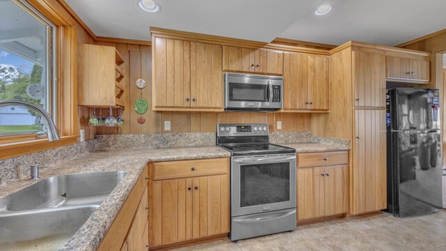 N133 Surfside Dr, Cedar Grove, WI 53013 - kitchen featuring appliances with stainless steel finishes, light countertops, recessed lighting, and wooden walls
