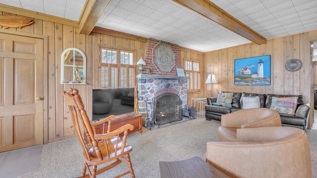 N133 Surfside Dr, Cedar Grove, WI 53013 - carpeted living room featuring wood walls, beam ceiling, and a stone fireplace