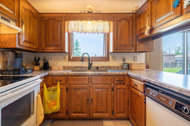 1360 Eminence St, Green Bay, WI 54313 - kitchen with white appliances, brown cabinetry, custom exhaust hood, and light countertops