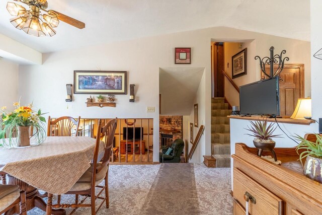 1360 Eminence St, Green Bay, WI 54313 - dining room with ceiling fan, stairs, lofted ceiling, and a fireplace