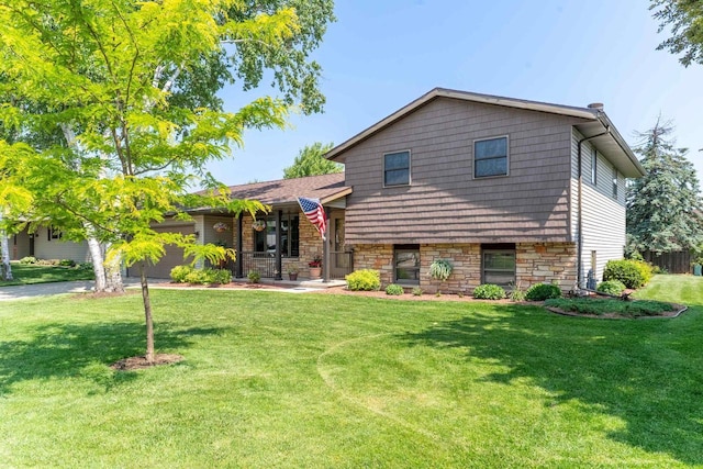 1360 Eminence St, Green Bay, WI 54313 - tri-level home featuring a front lawn, stone siding, and covered porch