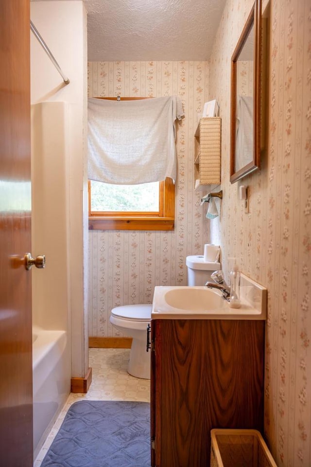 N8244 Woodland Trl, New Lisbon, WI 53950 - bathroom with vanity, a textured ceiling, and tub / shower combination