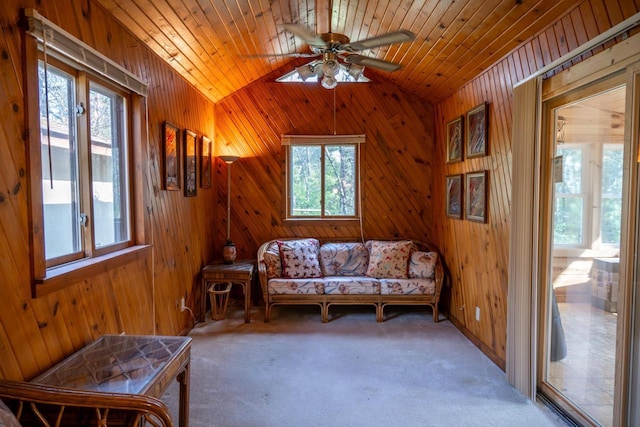 N8244 Woodland Trl, New Lisbon, WI 53950 - sitting room with wooden walls, lofted ceiling, ceiling fan, carpet flooring, and wood ceiling