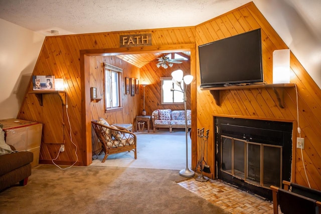 N8244 Woodland Trl, New Lisbon, WI 53950 - living room with wooden walls, carpet flooring, ceiling fan, and a fireplace with flush hearth