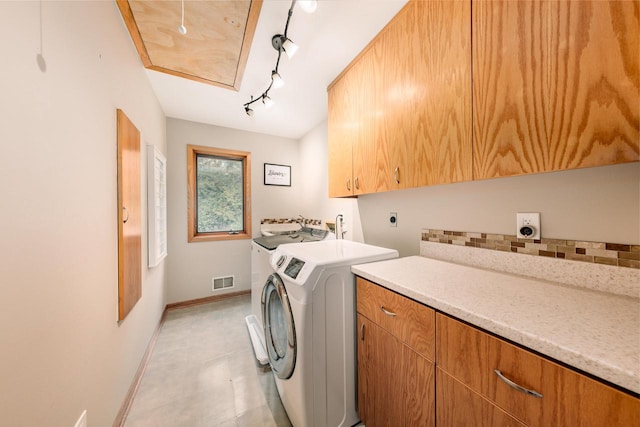 W301S1487 Brandybrook Rd, Waukesha, WI 53188 - washroom featuring cabinet space, rail lighting, washing machine and clothes dryer, and light tile patterned flooring