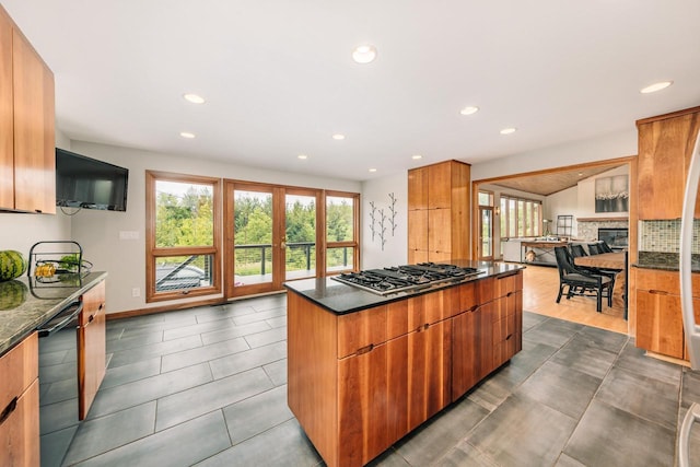 W301S1487 Brandybrook Rd, Waukesha, WI 53188 - kitchen featuring dishwasher, stainless steel gas stovetop, recessed lighting, dark stone counters, and a kitchen island
