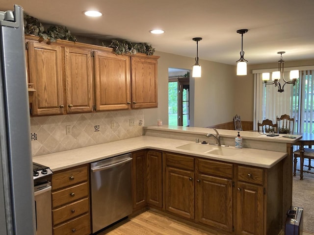 3988 S 18th St, Sheboygan, WI 53081 - kitchen featuring appliances with stainless steel finishes, a peninsula, tasteful backsplash, light countertops, and recessed lighting