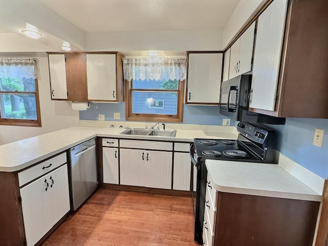 525 Pembrook Ct, Neenah, WI 54956 - kitchen featuring electric range, stainless steel dishwasher, light countertops, a peninsula, and light wood finished floors