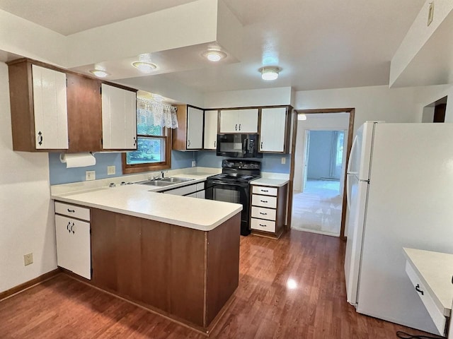 525 Pembrook Ct, Neenah, WI 54956 - kitchen featuring black appliances, light countertops, a peninsula, and dark wood-style flooring