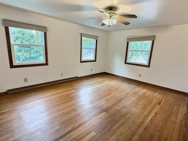 525 Pembrook Ct, Neenah, WI 54956 - unfurnished room featuring a baseboard radiator, wood finished floors, and ceiling fan