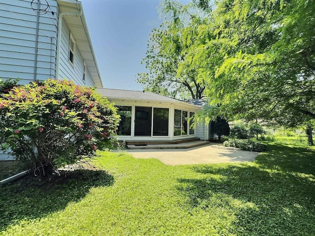 525 Pembrook Ct, Neenah, WI 54956 - view of green lawn featuring a patio area and a sunroom