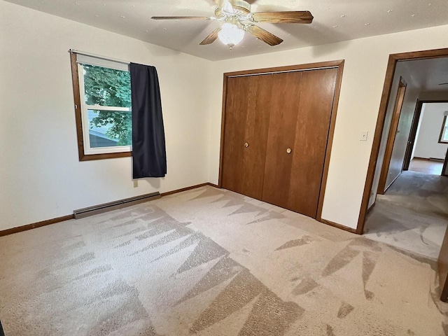 525 Pembrook Ct, Neenah, WI 54956 - unfurnished bedroom featuring a baseboard heating unit, carpet flooring, a closet, and ceiling fan