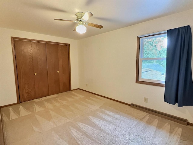525 Pembrook Ct, Neenah, WI 54956 - unfurnished bedroom with baseboard heating, light colored carpet, a closet, and ceiling fan