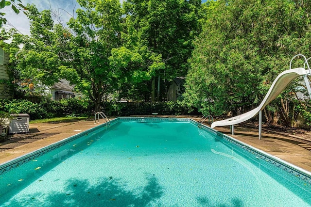 1329 23rd Ave, Monroe, WI 53566 - swimming pool featuring a water slide and a fenced backyard