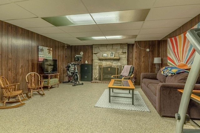 1329 23rd Ave, Monroe, WI 53566 - carpeted living area with a paneled ceiling, wooden walls, and a fireplace