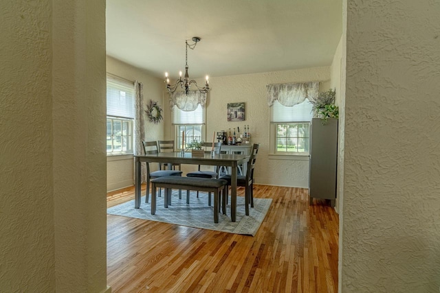 1329 23rd Ave, Monroe, WI 53566 - dining space featuring a textured wall, a chandelier, and wood finished floors
