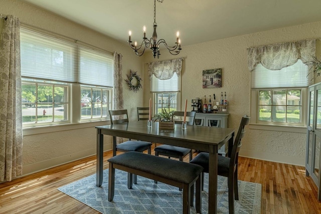 1329 23rd Ave, Monroe, WI 53566 - dining area featuring a textured wall, a chandelier, and wood finished floors