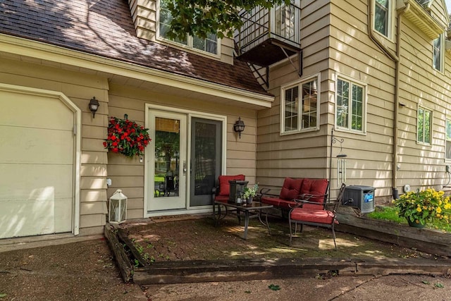 1329 23rd Ave, Monroe, WI 53566 - entrance to property featuring a balcony, a shingled roof, a patio area, and outdoor lounge area