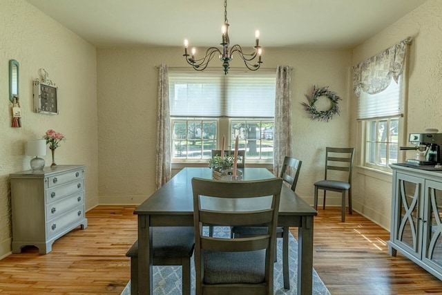 1329 23rd Ave, Monroe, WI 53566 - dining space featuring a chandelier, a textured wall, and light wood-type flooring