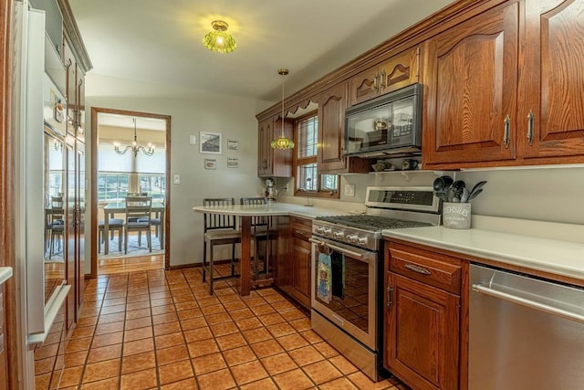 1329 23rd Ave, Monroe, WI 53566 - kitchen with stainless steel appliances, healthy amount of natural light, a chandelier, and light countertops
