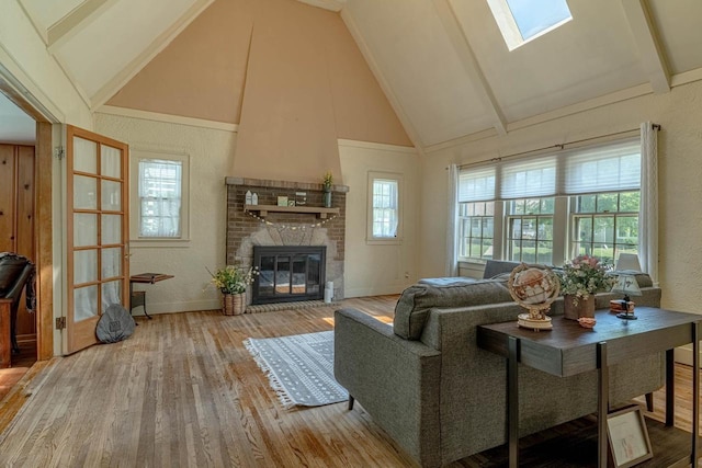 1329 23rd Ave, Monroe, WI 53566 - living area featuring wood finished floors, plenty of natural light, a fireplace, high vaulted ceiling, and beamed ceiling