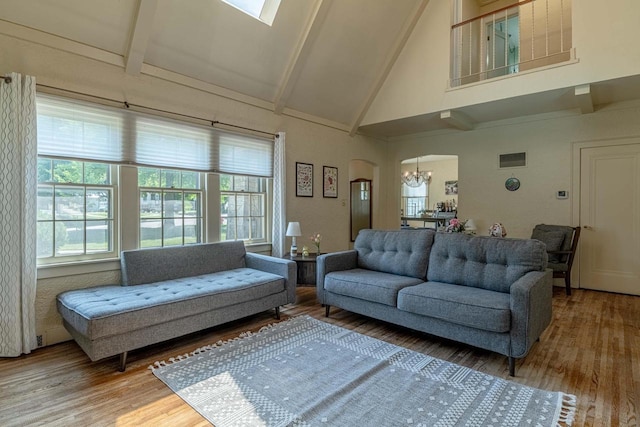 1329 23rd Ave, Monroe, WI 53566 - living area featuring a chandelier, high vaulted ceiling, wood finished floors, beam ceiling, and arched walkways
