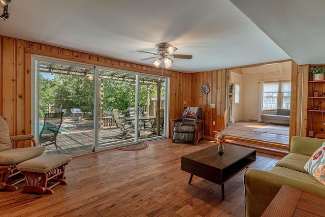 1329 23rd Ave, Monroe, WI 53566 - living room with ceiling fan, wood walls, healthy amount of natural light, and hardwood / wood-style flooring