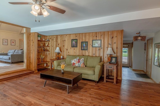 1329 23rd Ave, Monroe, WI 53566 - living room featuring ceiling fan, light wood-type flooring, and wood walls
