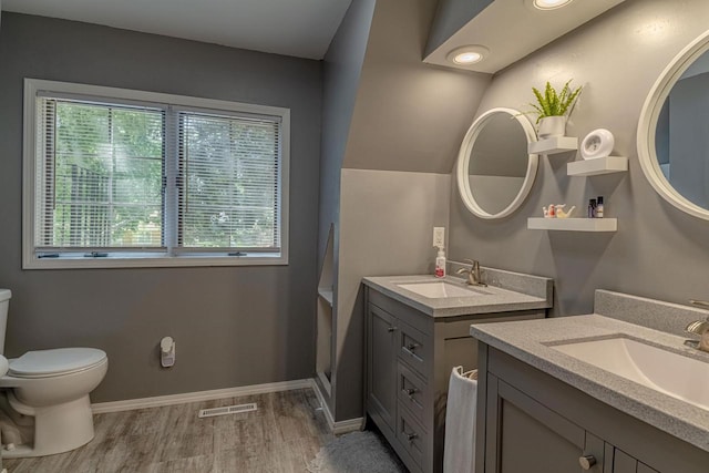 1329 23rd Ave, Monroe, WI 53566 - full bathroom featuring two vanities and wood finished floors