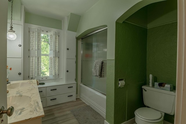 1329 23rd Ave, Monroe, WI 53566 - full bath with double vanity, wood finished floors, and shower / bath combination with glass door