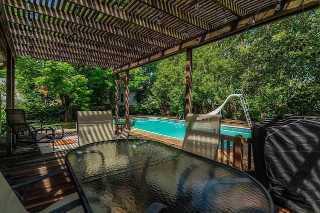 1329 23rd Ave, Monroe, WI 53566 - swimming pool with a water slide, a pergola, and outdoor dining space