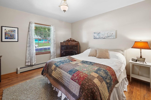 435 S Main St, Markesan, WI 53946 - bedroom with a baseboard radiator and wood finished floors