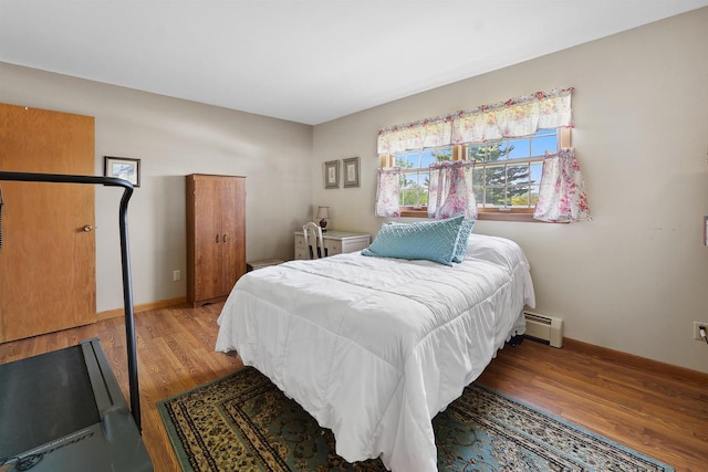 435 S Main St, Markesan, WI 53946 - bedroom featuring a baseboard heating unit and wood finished floors
